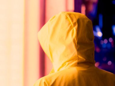 Soft silhouette of someone stretching against a bright window.