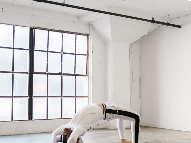 Wide view of a minimal yoga studio with natural light.
